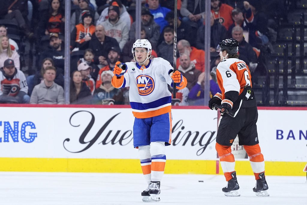 New York Islanders' Mathew Barzal, left, celebrates past Philadelphia Flyers' Travis Sanheim after scoring a goal during the second period of an NHL hockey game Monday, Jan. 26, 2026, in Philadelphia. (AP Photo/Matt Slocum)