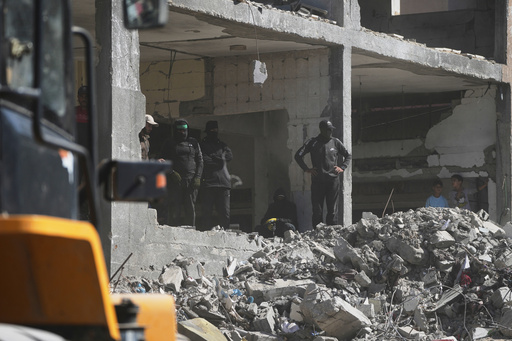 Members of the al-Qassam Brigades, the military wing of Hamas, along with Egyptian workers and machinery, search for the bodies of hostages in Nuseirat, Gaza Strip, Tuesday, Oct. 28, 2025. (AP Photo/Abdel Kareem Hana) Members of the al-Qassam Brigades, the military wing of Hamas, along with Egyptian workers and machinery, search for the bodies of hostages in Nuseirat, Gaza Strip, Tuesday, Oct. 28, 2025. (AP Photo/Abdel Kareem Hana)
