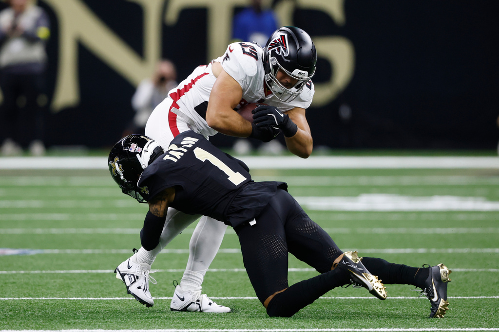Atlanta Falcons tight end Charlie Woerner, top, is tackled by New Orleans Saints cornerback Alontae Taylor (1) in the first half of an NFL football game, Sunday, Nov. 23, 2025, in New Orleans. (AP Photo/Butch Dill)