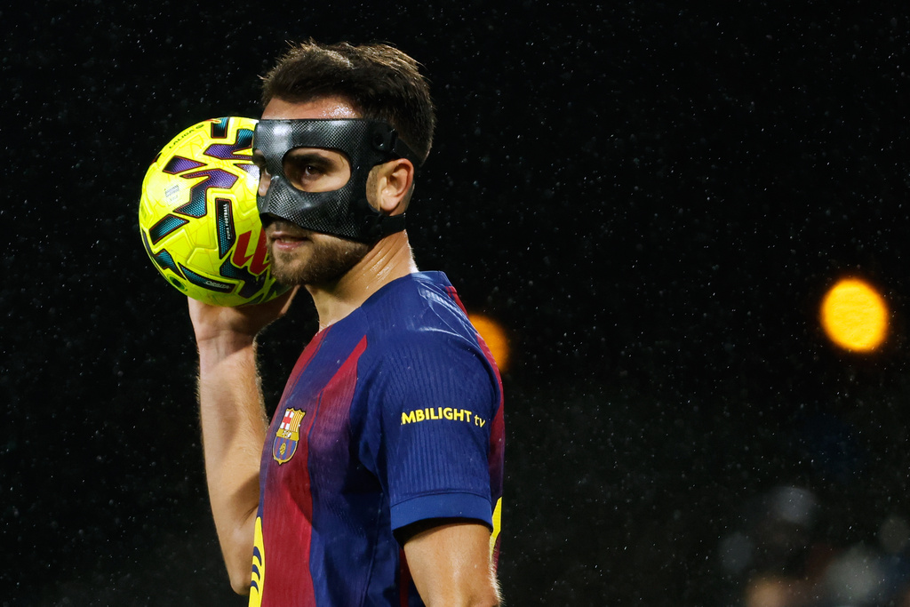 Barcelona's Eric Garcia holds the ball during the Spanish La Liga soccer match between Celta Vigo and Barcelona in Vigo, Spain, Sunday, Nov. 9, 2025. (AP Photo/Lalo R. Villar)