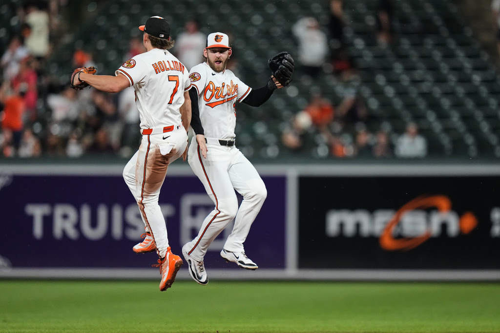 Baltimore Orioles second baseman Jackson Holliday (7) and left fielder Taylor Ward, right, celebrate their team's victory over the Tampa Bay Rays in a baseball game, Tuesday, May 26, 2026, in Baltimore. (AP Photo/Stephanie Scarbrough)