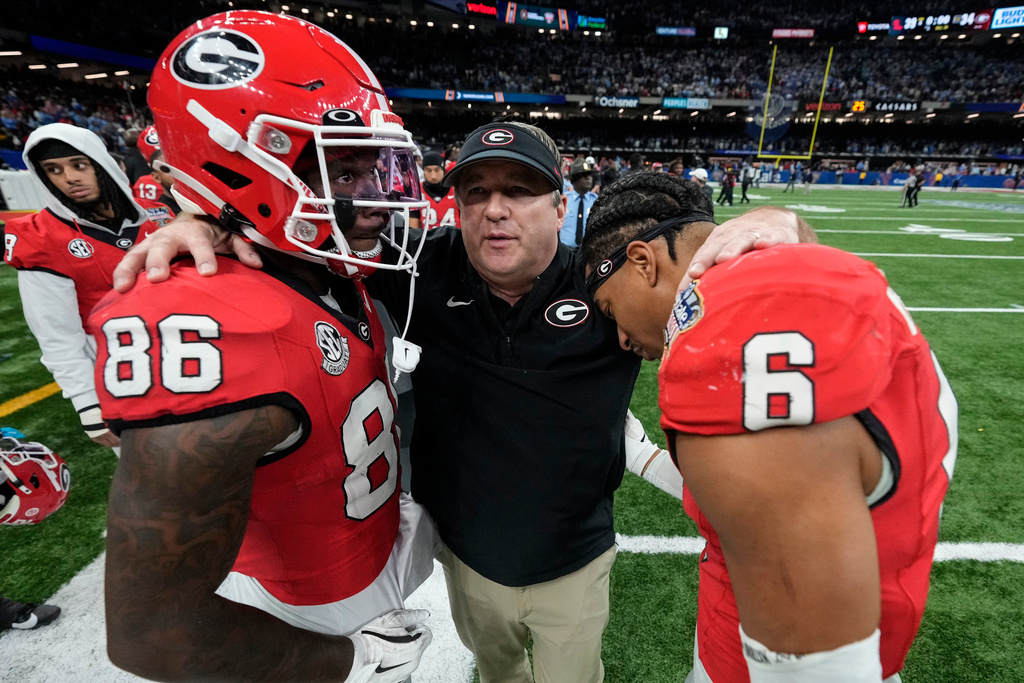 Georgia head coach Kirby Smart embarces his players after a loss to Mississippi after the Sugar Bowl NCAA college football playoff quarterfinal game, Friday, Jan. 2, 2026, in New Orleans. (AP Photo/Gerald Herbert)
