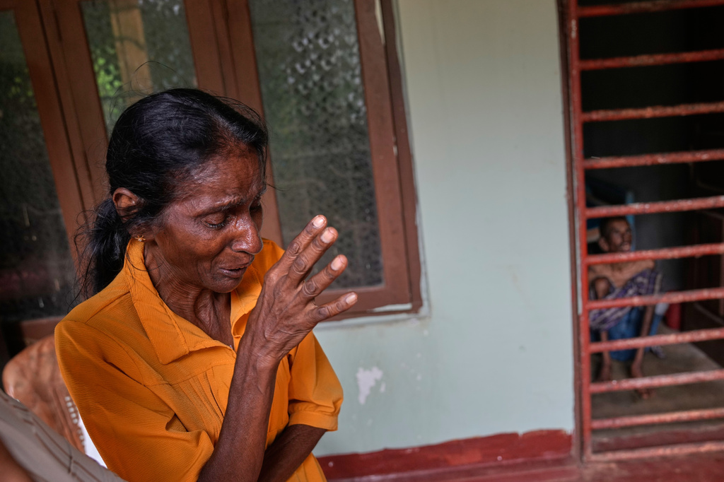 Dolawatte Mudiyanselage Chandra, left, cries as she speaks about her mentally challenged son, right, at a nursing home, where inmates of another nursing home that caught fire on Wednesday are being temporarily housed, in Anguruwatota, Sri Lanka, Friday, June 5, 2026.(AP Photo/Eranga Jayawardena)