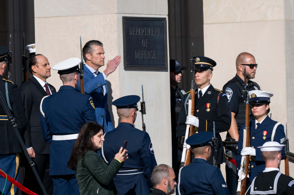 Defense Secretary Pete Hegseth salutes during a welcome ceremony for Qatar Minister of Defense Sheikh Saoud Al Thani, left, at the Pentagon, Friday, Oct. 10, 2025 in Washington. (AP Photo/Kevin Wolf)