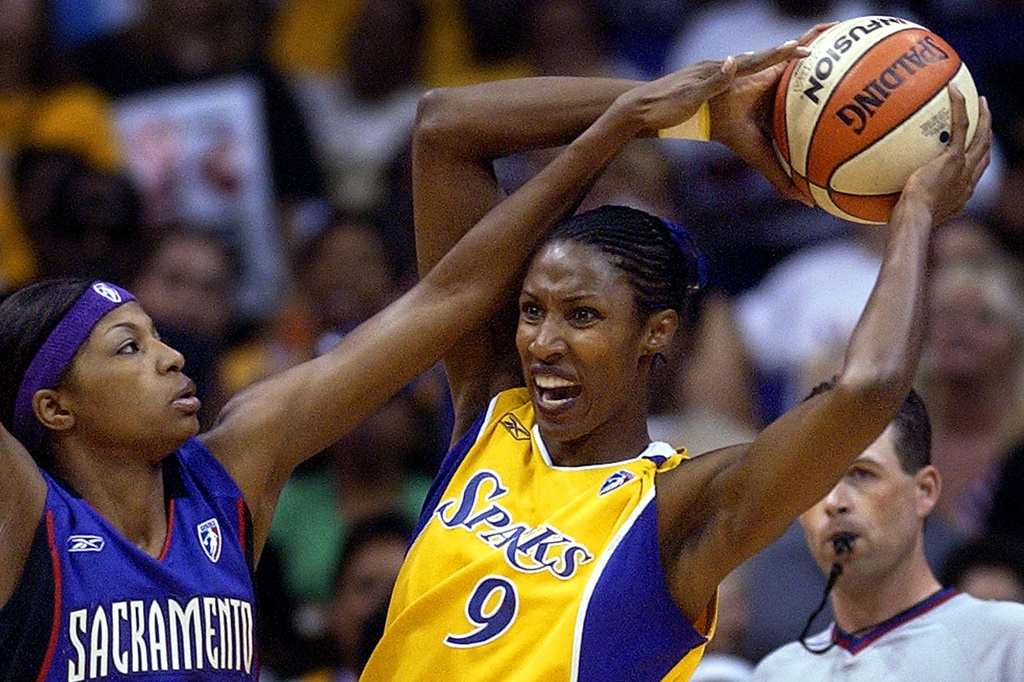 FILE - Los Angeles Sparks' Lisa Leslie gets set to pass the ball as Sacramento Monarchs' DeMya Walker guards during the first half in Game 2 of the WNBA basketball Western Conference Finals, Sunday, Sept. 7, 2003, in Los Angeles. (AP Photo/Mark J. Terrill, File)