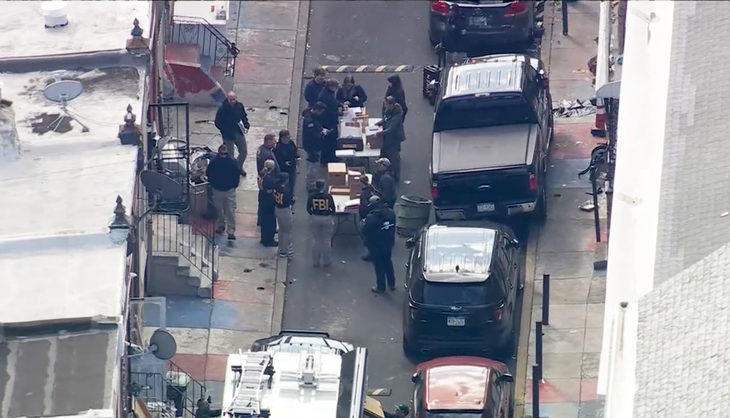 FBI agents are outside a building after a raid in the Kensington section of Philadelphia on Friday, Oct. 24, 2025. (WPVI via AP)