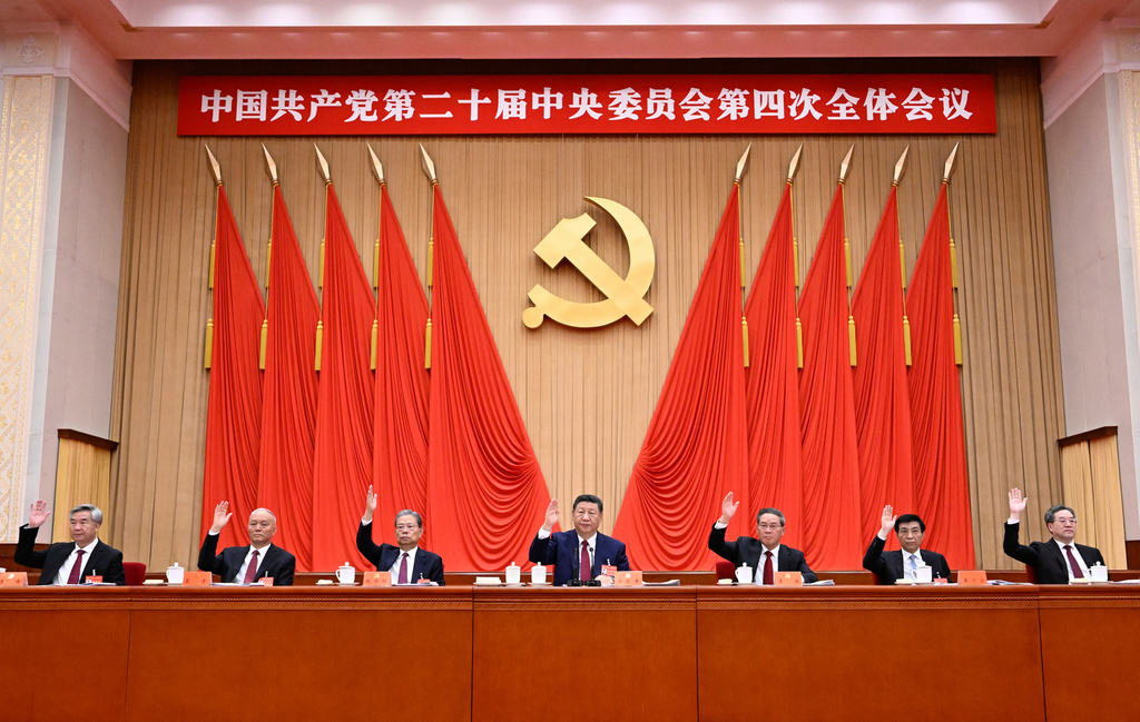 In this photo released by Xinhua News Agency on Thursday, Oct 23, 2025, Chinese President Xi Jinping center leads other members of the Politburo standing committee during the fourth plenary session of the 20th Communist Party of China (CPC) Central Committee in Beijing. (Shen Hong/Xinhua via AP)