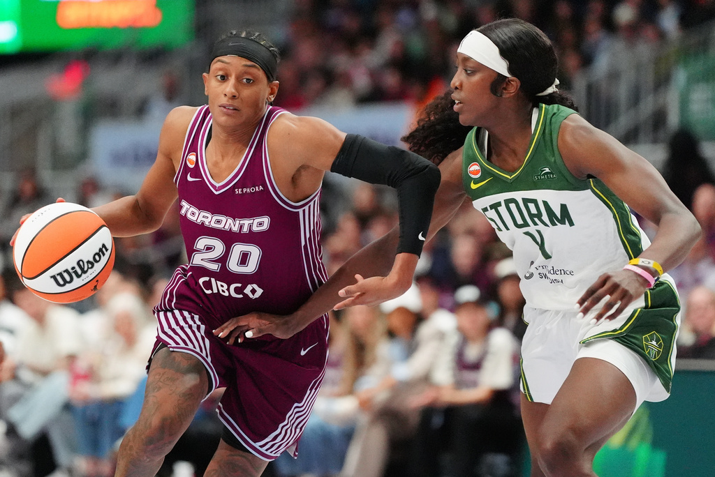 Toronto Tempo's Brittney Sykes (20) drives around Seattle Storm's Flau'jae Johnson (4) during second half WNBA basketball action in Toronto, on Wednesday, May 13, 2026. (Frank Gunn/The Canadian Press via AP)