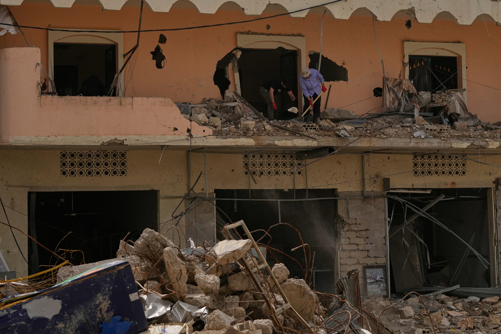 Residents remove rubble from their destroyed house on the second day of a ceasefire between Hezbollah and Israel in Jibchit village, south Lebanon, Saturday, April 18, 2026.(AP Photo/Mohammed Zaatari)