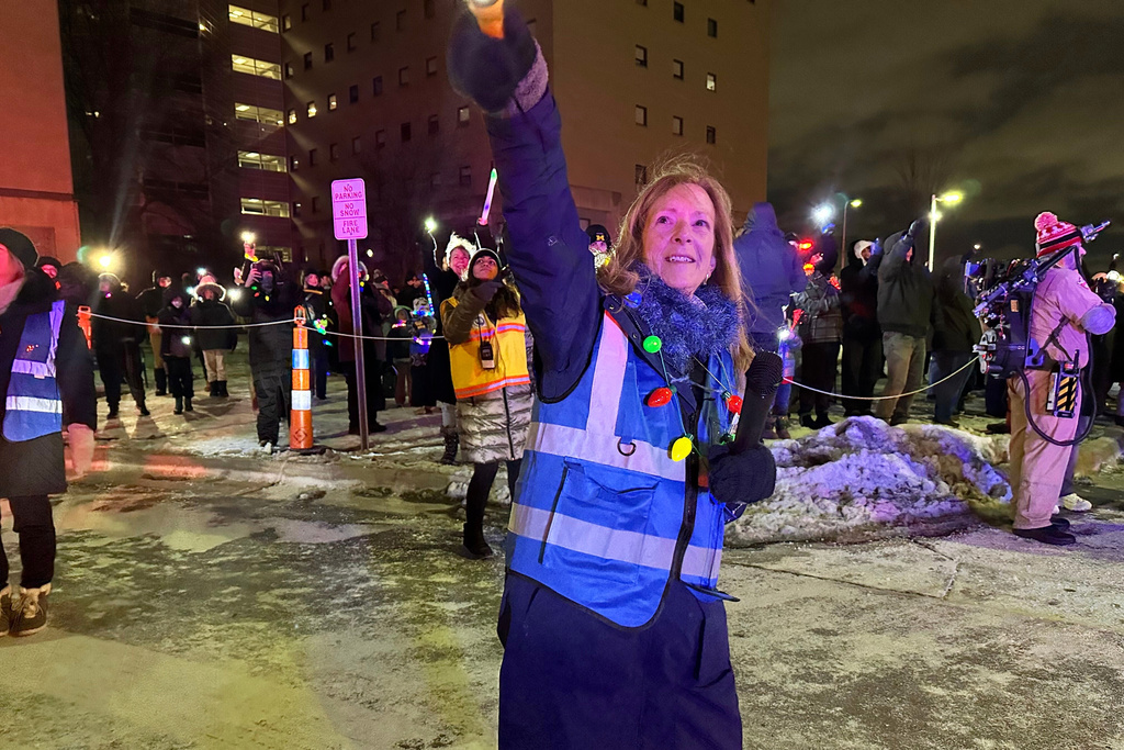 Lisa Muma, one of the organizers of Moonbeams for Sweet Dreams, shines a light up into the pediatric wing of Corewell Health Children's during an event Saturday, Dec. 13, 2025, in Royal Oak, Mich. (AP Photo/Mike Householder)