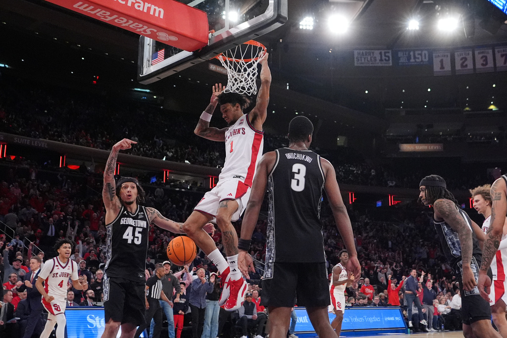 St. John's Red Storm's Dillon Mitchell (1) dunks the ball in front of Georgetown Hoyas' Kayvaun Mulready (45) and Vincent Iwuchukwu (3) during the second half of an NCAA college basketball game Tuesday, March 3, 2026, in New York. (AP Photo/Frank Franklin II)