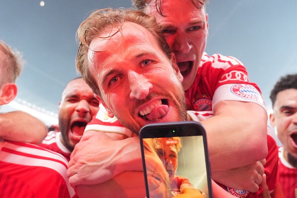 Bayern's Harry Kane, front celebrates with Joshua Kimmich after Kane scored his third goal during the DFB Pokal, German Cup final soccer match between VfB Stuttgart and Bayern Munich in Berlin, Germany, Saturday, May 23, 2026. (Michael Kappeler/dpa via AP)