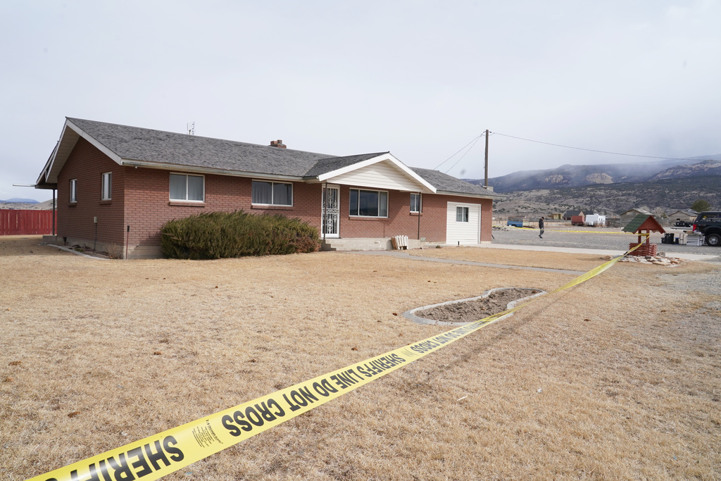 Crime tape surrounds a home where a woman was found dead in Lyman, Utah, Thursday, March 5, 2026. (AP Photo/George Frey)