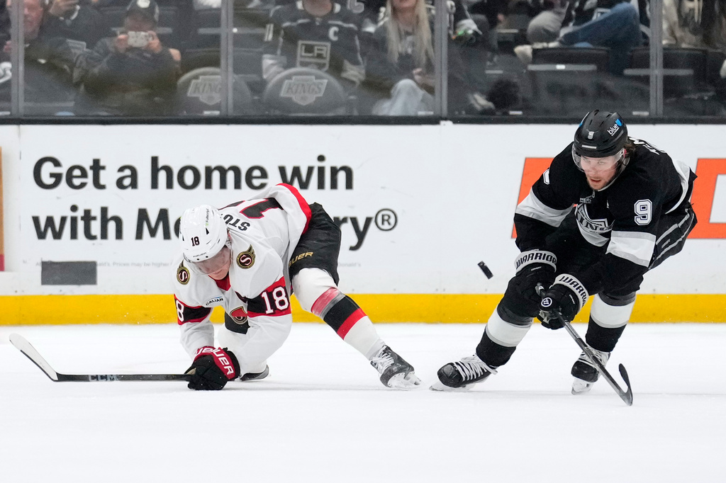 Ottawa Senators center Tim Stutzle, left, and Los Angeles Kings right wing Adrian Kempe battle for the puck during the first period of an NHL hockey game Thursday, Oct. 29, 2026, in Los Angeles. (AP Photo/Mark J. Terrill)