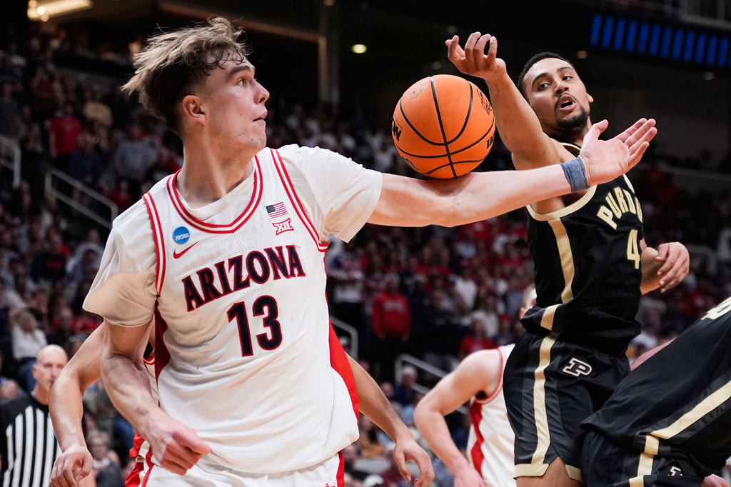 Arizona center Motiejus Krivas (13) reaches for a rebound next to Purdue forward Trey Kaufman-Renn (4) during the second half in the Elite Eight of the NCAA college basketball tournament, Saturday, March 28, 2026, in San Jose, Calif. (AP Photo/Godofredo A. Vásquez)