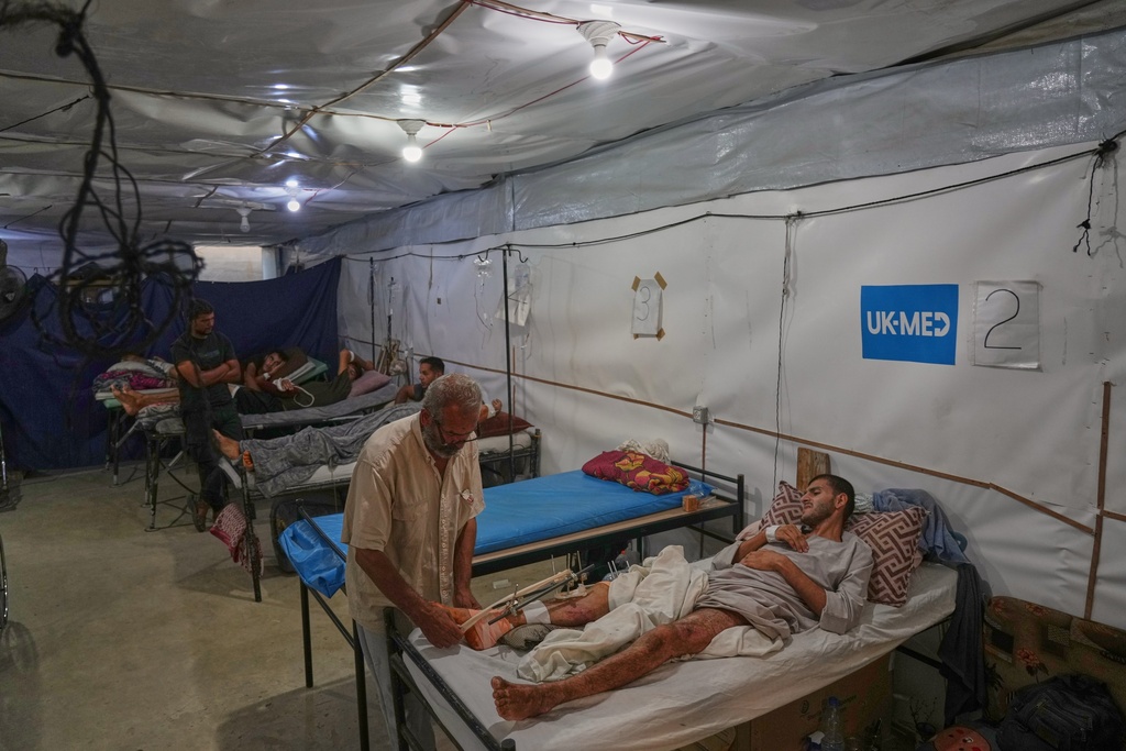 Patients receive care at a field hospital run by the British humanitarian medical NGO UK-Med in Muwasi, near Khan Younis, southern Gaza Strip, Saturday, Sept. 27, 2025. (AP Photo/Jehad Alshrafi)