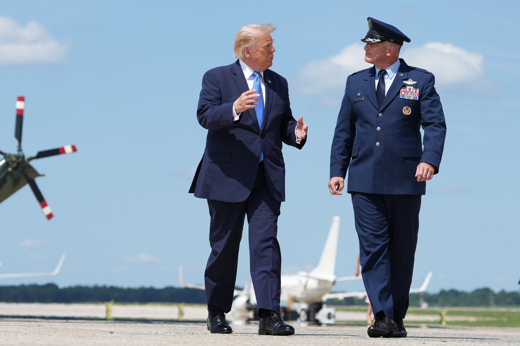 President Donald Trump walks from Marine One with Air Force Col. Christopher M. Robinson, commander of the 89th Airlift Wing, to board Air Force One, Tuesday, Aug. 4, 2026, at Joint Base Andrews, Md. (AP Photo/Mark Schiefelbein)