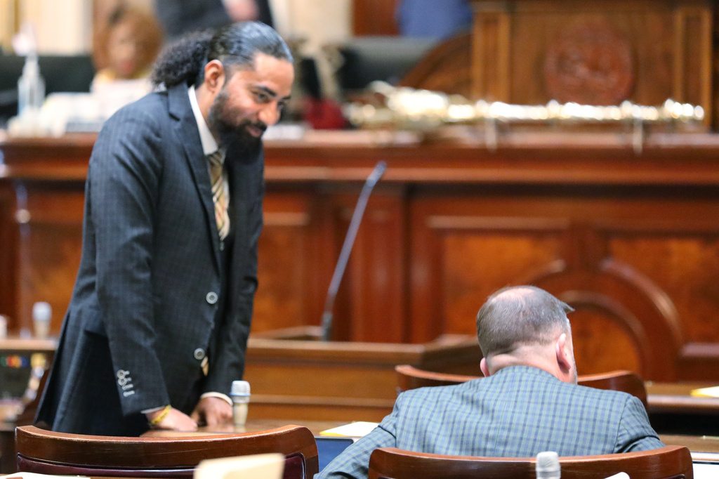 Democratic South Carolina Rep. Justin Bamberg, left, talks to Republican Rep. Neal Collins, right, before the House session on redistricting on Monday, May 18, 2026, in Columbia, S.C. (AP Photo/Jeffrey Collins).