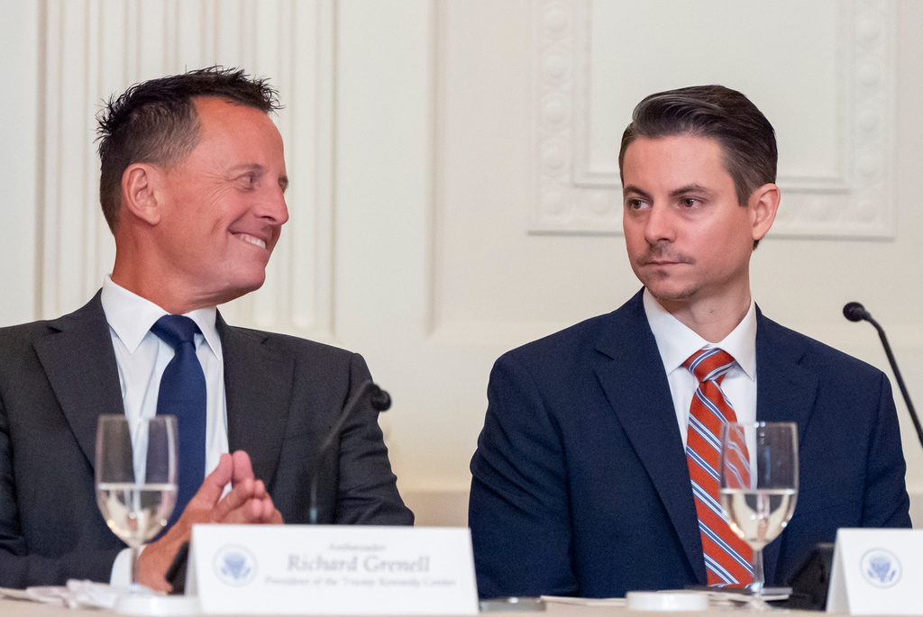 Kennedy Center President Richard Grenell, left, and Matt Floca are seated as President Donald Trump speaks during a board meeting of the John F. Kennedy Memorial Center For The Performing Arts in the East Room of the White House, Monday, March 16, 2026, in Washington. (AP Photo/Alex Brandon)