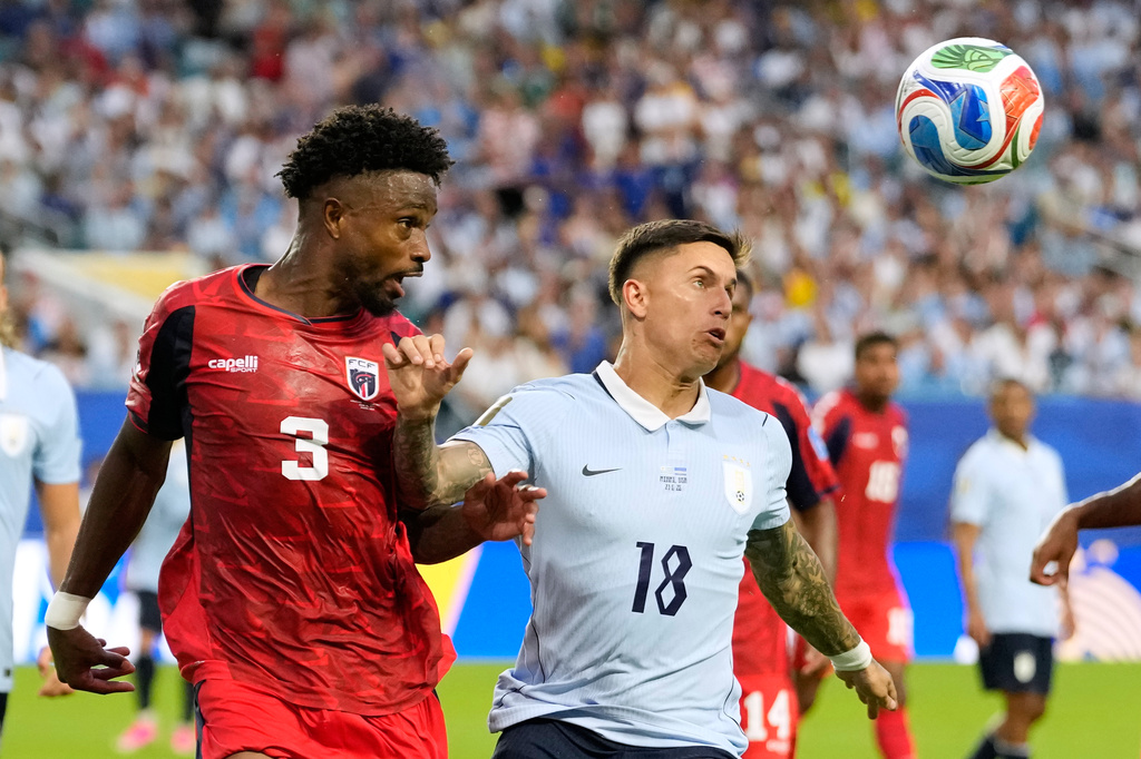 Cape Verde's Diney Borges (3) and Uruguay's Brian Rodriguez (18) battle for the ball during the World Cup Group H soccer match between Uruguay and Cape Verde in Miami Gardens, Fla., Sunday, June 21, 2026. (AP Photo/Rebecca Blackwell)