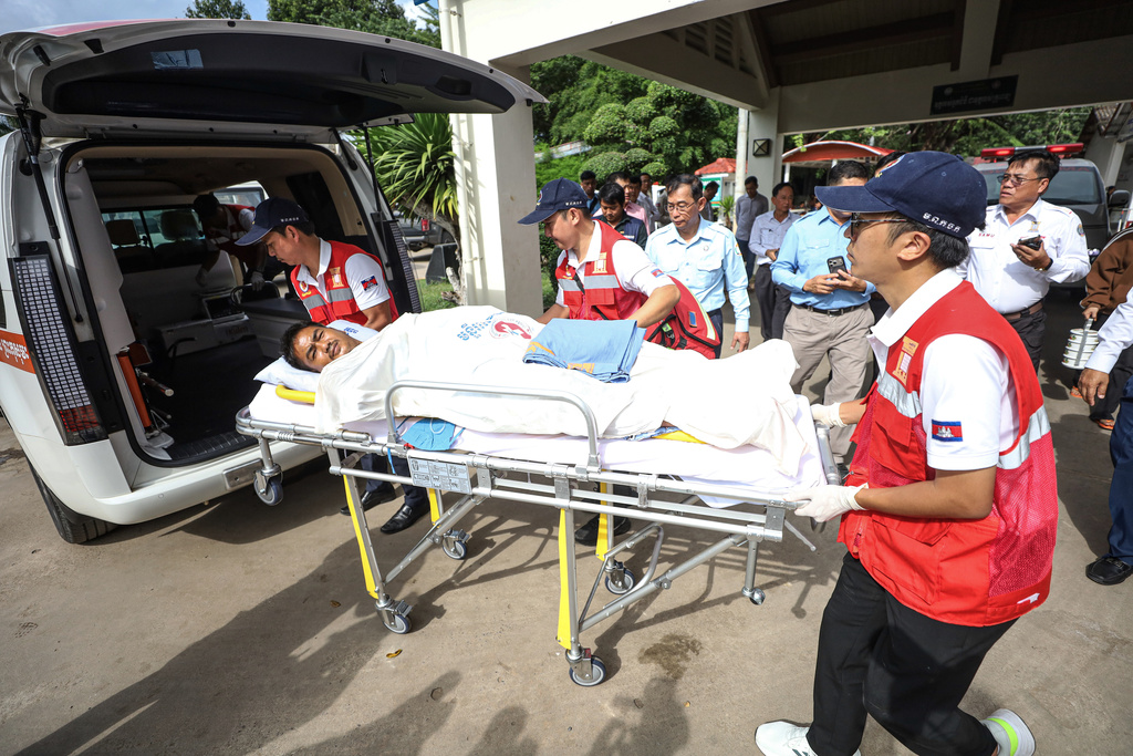 In this photo released by Agence Kampuchea Press (AKP), a man on a medical emergency stretcher is carried into an ambulance on the way to the main hospital after he was injured in Prey Chan village, Banteay Meanchey province, a border town to Thailand, on Thursday, Nov. 13, 2025 (AKP via AP)