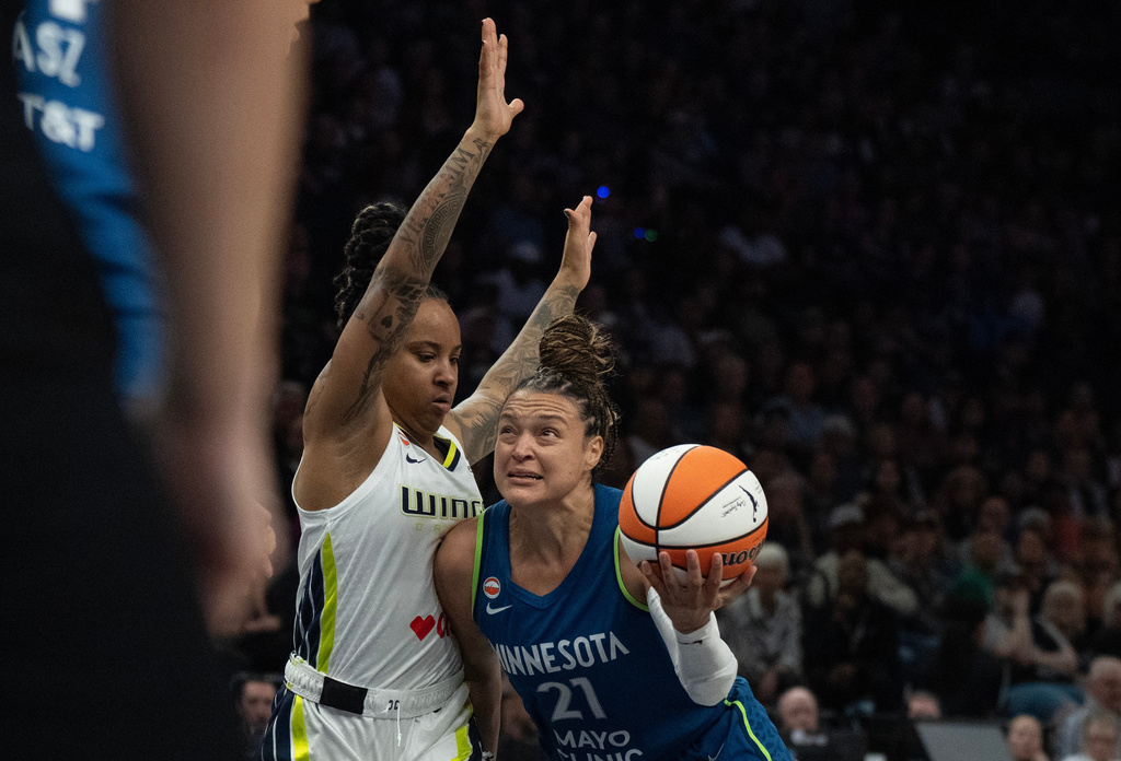 Minnesota Lynx guard Kayla McBride (21) dribbles to the basket on Dallas Wings guard Aziaha James in the fist half of basketball game, Sunday Aug. 9, 2026 in Minneapolis. (Jerry Holt/Minnesota Star Tribune via AP)