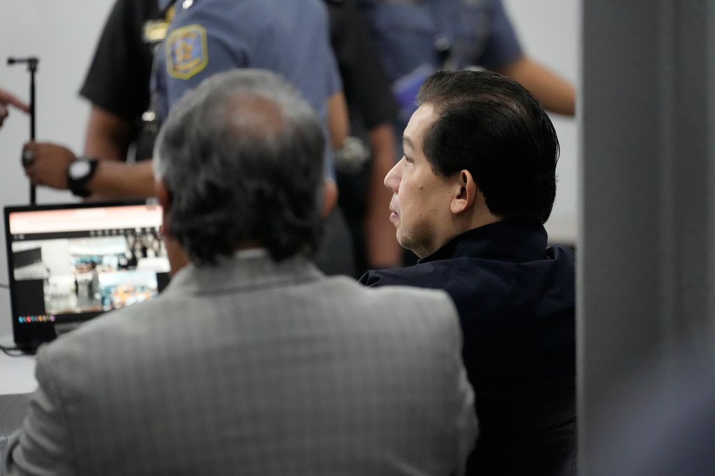 Philippines former House Speaker Martin Romualdez, right, a cousin of President Ferdinand Marcos Jr., waits for the start of his arraignment via video conference at the Quezon City Jail in Quezon, Philippines, Wednesday, Sept. 16, 2026. (AP Photo/Aaron Favila, Pool)