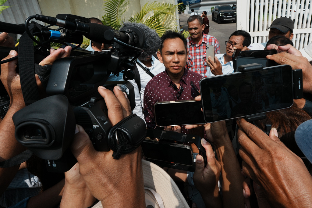 Am Sam Ath, center, monitoring manager of LICADHO, a human rights organization, speaks to journalists after a court session of former Cambodia National Rescue Party's President Kem Sokha outside an appeals court in Phnom Penh, Cambodia, Thursday, April 30, 2026. (AP Photo/Heng Sinith)