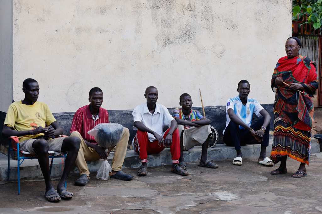 Young men and boys who fled drought in South Sudan sit alongside a chief in Torit, the capital of Eastern Equatoria state, South Sudan, Friday, Aug. 14, 2026. (AP Photo/Juma Peter)