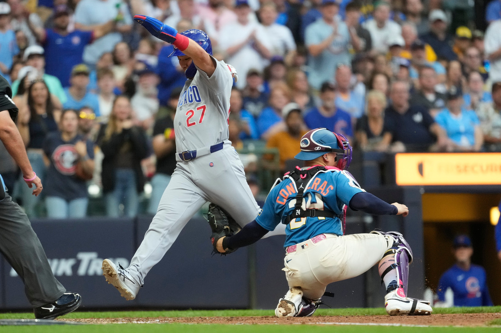 Chicago Cubs' Seiya Suzuki (27) is tagged out at home by Milwaukee Brewers' William Contreras, right, during the seventh inning of a baseball game Saturday, June 27, 2026, in Milwaukee. (AP Photo/Aaron Gash)