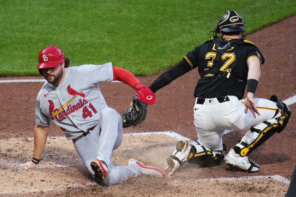 St. Louis Cardinals' Alec Burleson (41) slides safely past the tag attempt by Pittsburgh Pirates catcher Henry Davis, scoring on a sacrifice fly by Nolan Gorman off Pirates pitcher Hunter Barco during the fifth inning of a baseball game in Pittsburgh, Thursday, April 28, 2026. (AP Photo/Gene J. Puskar)