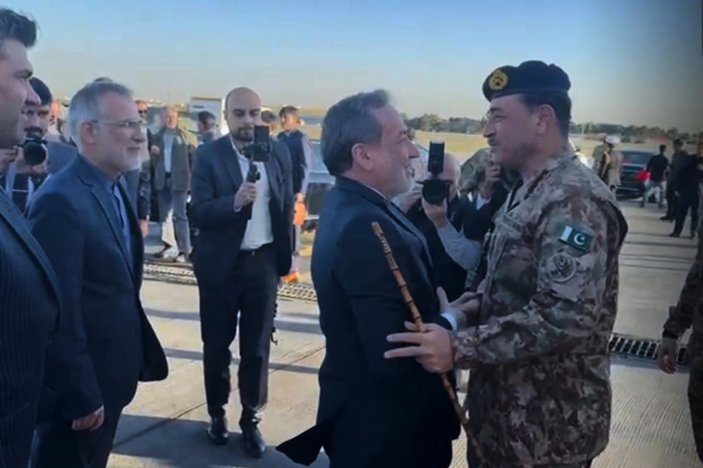 In this photo provided by military media wing Inter Services Public Relations, Pakistan's Army Chief Field Marshal Asim Munir, right, is greeted by Iranian Foreign Minister Abbas Araghchi upon his arrival in Tehran, Iran, Wednesday, April 15, 2026. (Inter Services Public Relations via AP)
