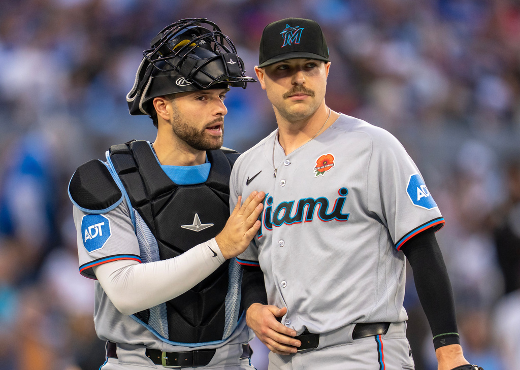 Miami Marlins catcher Joe Mack, left, gives starting pitcher Janson Junk, right, a congratulatory pat following fourth-inning baseball game action against the Toronto Blue Jays in Toronto, Monday May 25, 2026. (Frank Gunn/The Canadian Press via AP)