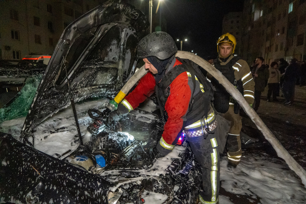 Rescuers put out the fire at a residential neighborhood following Russia's drone attack in Kharkiv, Ukraine, late Monday, March 9, 2026. (AP Photo/Andrii Marienko)