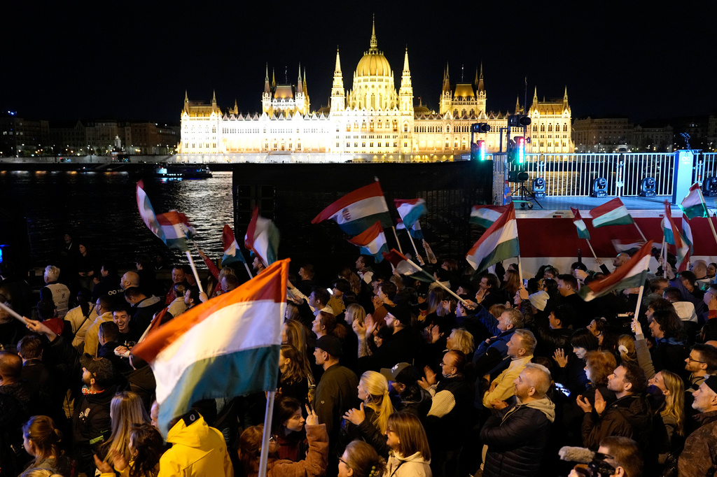 Supporters of Peter Magyar, the leader of the opposition Tisza party celebrates after a parliamentary election in Budapest, Hungary, Sunday, April 12, 2026. (AP Photo/Darko Bandic)