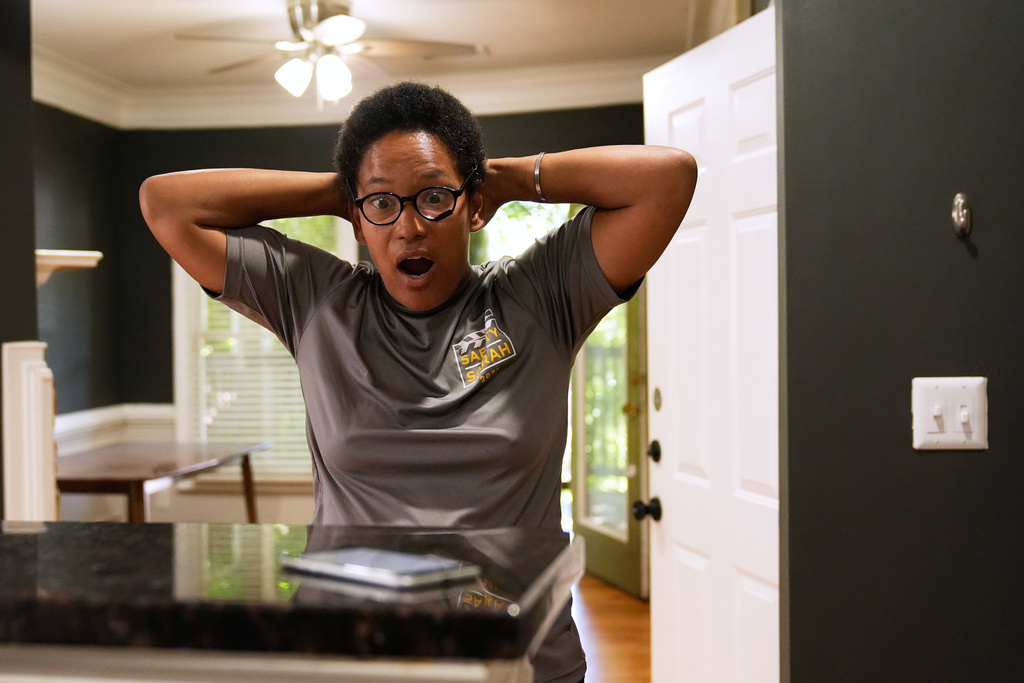 Sechita McNair reacts as the utility company tells her they cannot turn on the water in her new Atlanta apartment due to a previous renter's unpaid bill on Aug. 1, 2025. (AP Photo/Brynn Anderson)