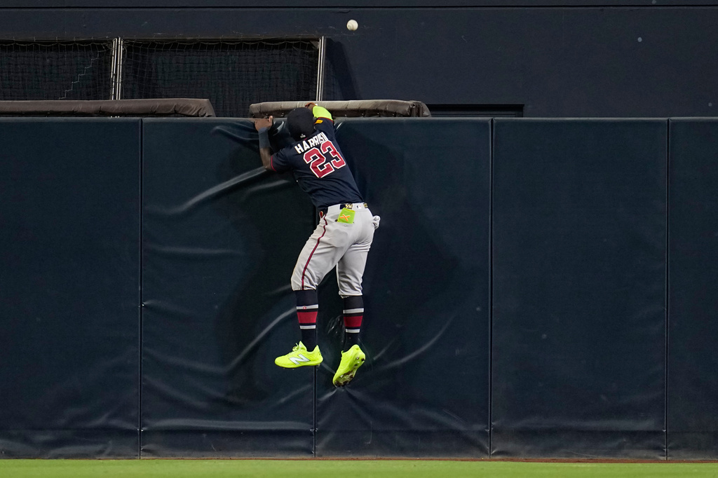 Atlanta Braves center fielder Michael Harris II can't reach a home run hit by San Diego Padres' Fernando Tatis Jr. during the seventh inning of a baseball game Tuesday, June 23, 2026, in San Diego. (AP Photo/Gregory Bull)