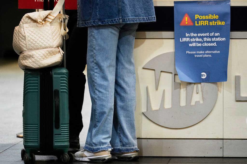 A sign warns commuters of a potential Long Island Rail Road strike at Penn Station in New York, Thursday, May 14, 2026. (AP Photo/Seth Wenig)