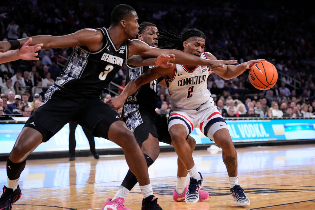 UConn guard Silas Demary Jr. (2) is blocked by Georgetown center Vincent Iwuchukwu (3) during the first half of an NCAA college basketball game in the semifinals of the Big East tournament, Friday, March 13, 2026, in New York. (AP Photo/Yuki Iwamura)