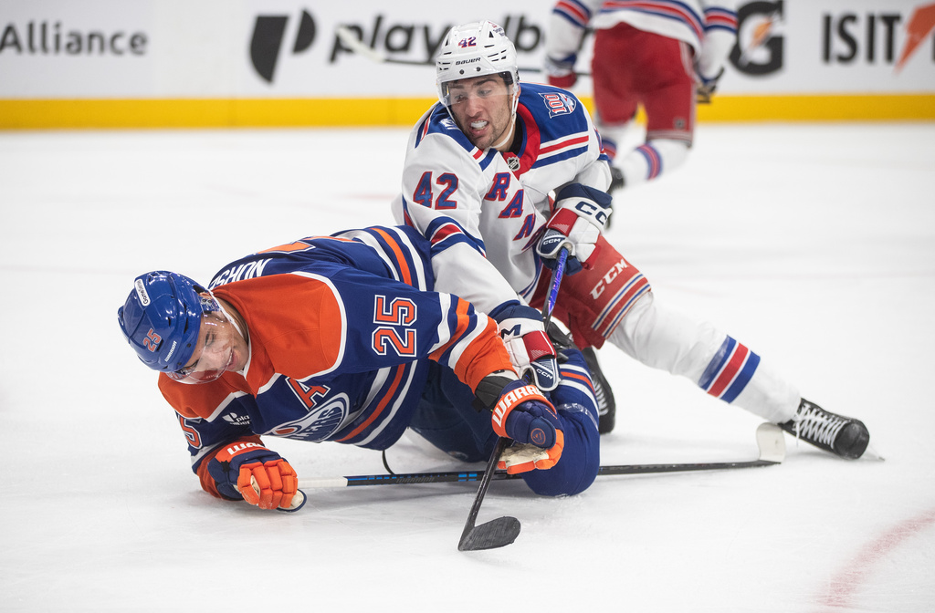 New York Rangers' Noah Laba (42) and Edmonton Oilers' Darnell Nurse (25) become entangled during third-period NHL hockey game action in Edmonton, Alberta, Thursday, Oct. 30, 2025. (Jason Franson/The Canadian Press via AP)