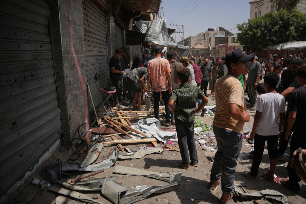 Palestinians inspect the site of an Israeli military strike, in Deir al-Balah, central Gaza Strip, Saturday, July 25, 2026. (AP Photo/Abdel Kareem Hana)