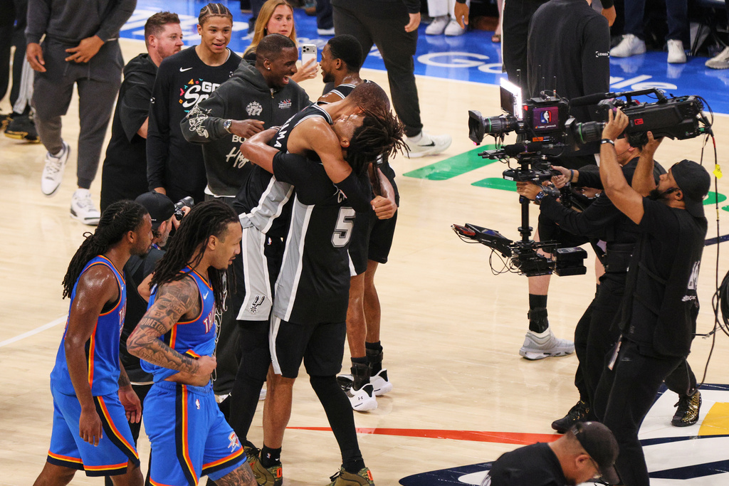 San Antonio Spurs forward Victor Wembanyama and guard Stephon Castle (5) celebrate after defeating the Oklahoma City Thunder in Game 7 of the Western Conference finals of the NBA basketball playoffs series Saturday, May 30, 2026, in Oklahoma City. (AP Photo/Nate Billings)