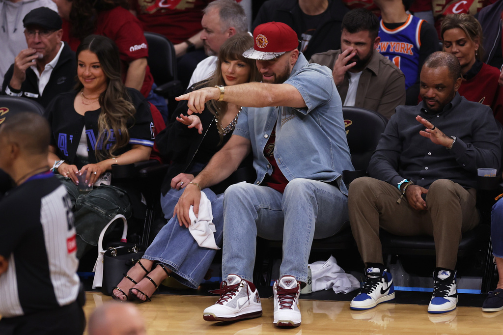 FILE - Taylor Swift and Travis Kelce watch the second half of Game 3 in the Eastern Conference finals NBA basketball playoffs series between the New York Knicks and the Cleveland Cavaliers in Cleveland, May 23, 2026. (AP Photo/Tim Phillis, File)