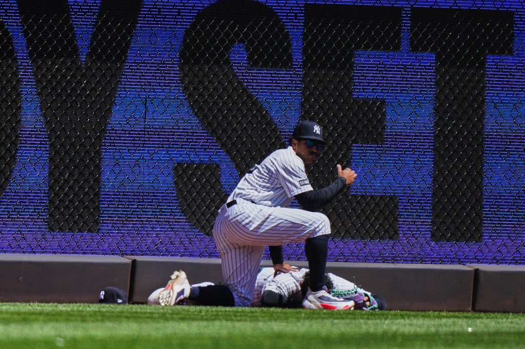New York Yankees' Jasson Domínguez is injured while catching a ball hit by Texas Rangers' Brandon Nimmo for an out during the first inning of a baseball game Thursday, May 7, 2026, in New York. (AP Photo/Frank Franklin II)