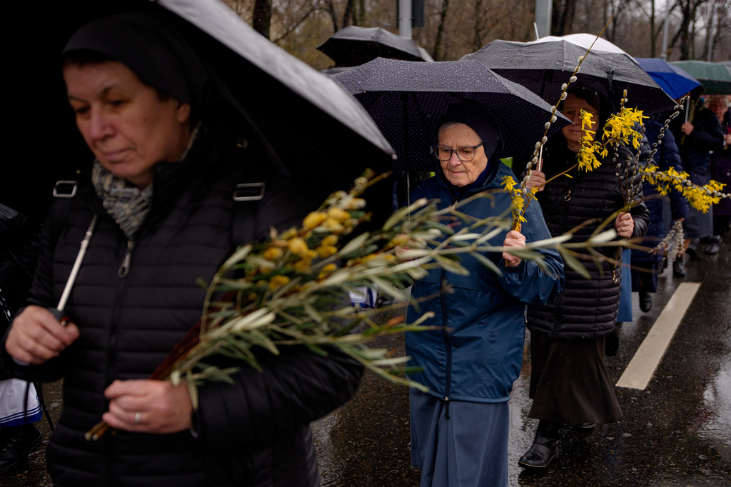 Catholic nuns walk during a Palm Sunday procession in Bucharest, Romania, Sunday, March 29, 2026. (AP Photo/Andreea Alexandru)