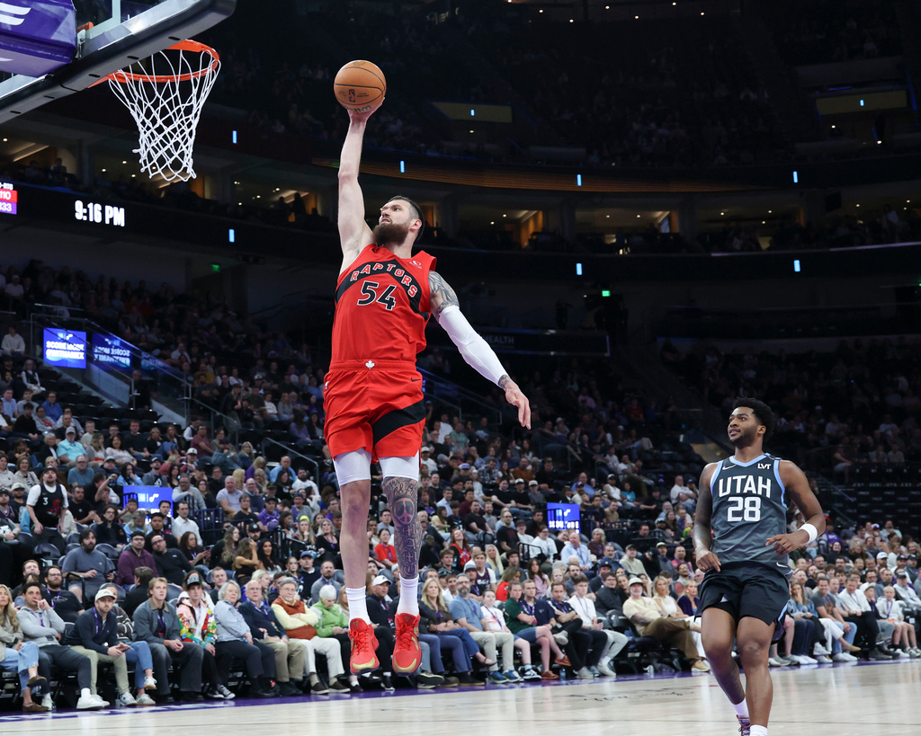 Toronto Raptors forward Sandro Mamukelashvili (54) goes up for a dunk against the Utah Jazz during the second half of an NBA basketball game, Monday, March 23, 2026, in Salt Lake City. (AP Photo/Rob Gray)