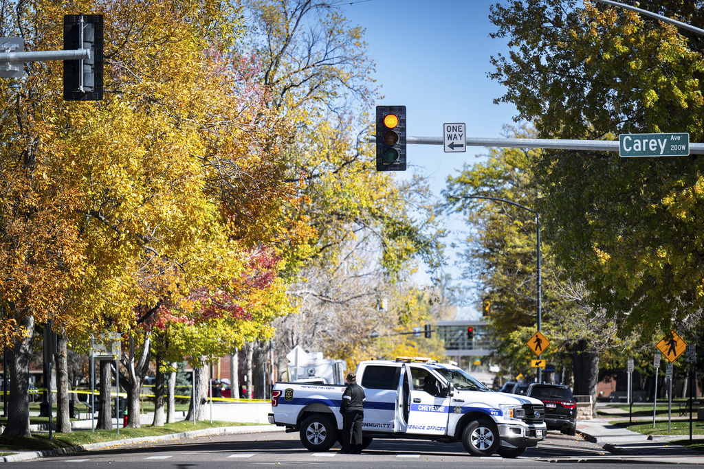 A Cheyenne Police Department community service officer blocks the road in front of the Wyoming Capitol after a suspected improvised explosive device (IED) was found at the state Capitol on Tuesday, Oct. 21, 2025, in Cheyenne, Wyo. (Milo Gladstein/The Wyoming Tribune Eagle via AP)