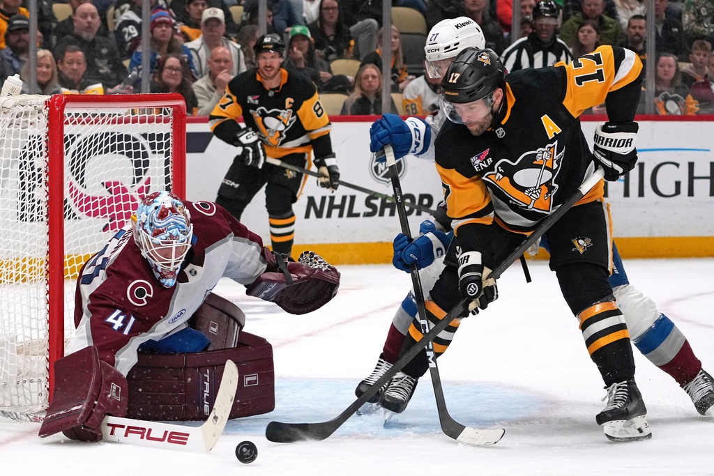 Pittsburgh Penguins' Bryan Rust (17) can't get his stick on the puck in front of Colorado Avalanche goaltender Scott Wedgewood (41) with Brett Kulak (27) defending during the second period of an NHL hockey game in Pittsburgh, Tuesday, March 24, 2026. (AP Photo/Gene J. Puskar)