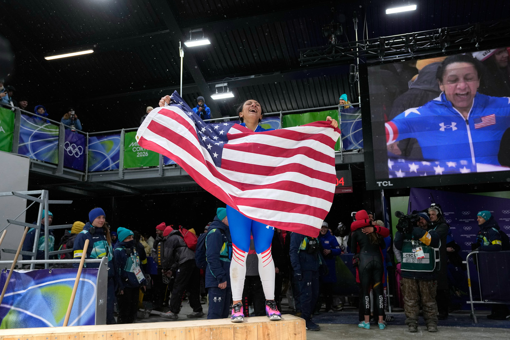 United States' gold medalist Elana Meyers Taylor celebrates at the finish after the women's monobob competition at the 2026 Winter Olympics, in Cortina d'Ampezzo, Italy, Monday, Feb. 16, 2026. (AP Photo/Alessandra Tarantino)