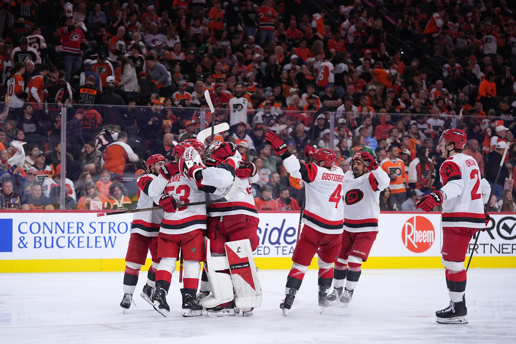 Carolina Hurricanes' players celebrate after winning Game 4 against the Philadelphia Flyers in a second-round NHL hockey Stanley Cup playoff series Saturday, May 9, 2026, in Philadelphia. (AP Photo/Matt Slocum)